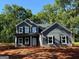 Charming two-story home featuring gray siding, a covered front porch, and black shutters at 148 Asa Moseley Rd, Mcdonough, GA 30252