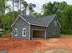 New construction featuring an attached garage, board and batten siding and white framed windows at 148 Asa Moseley Rd, Mcdonough, GA 30252