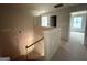 Hallway with staircase and doorways to bedrooms, painted in neutral color at 148 Asa Moseley Rd, Mcdonough, GA 30252
