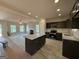 Open kitchen features new floors, granite countertops, black appliances, and a kitchen island at 148 Asa Moseley Rd, Mcdonough, GA 30252