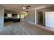 Open layout features new floors, a ceiling fan, fireplace, kitchen, and a staircase at 148 Asa Moseley Rd, Mcdonough, GA 30252