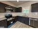 Features granite counters, stainless appliances, tile backsplash, undermount sink and new floors at 148 Asa Moseley Rd, Mcdonough, GA 30252
