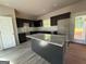 Modern kitchen features a granite island, dark cabinetry, and sleek countertops at 148 Asa Moseley Rd, Mcdonough, GA 30252