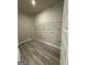 Practical laundry room features new floors, fresh paint, hookups, and wire shelving for storage at 148 Asa Moseley Rd, Mcdonough, GA 30252