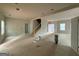 Unfinished Living Room showcasing large windows, open floor plan and staircase at 148 Asa Moseley Rd, Mcdonough, GA 30252