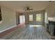 Living room featuring contemporary flooring, a cozy fireplace, and bright windows at 148 Asa Moseley Rd, Mcdonough, GA 30252