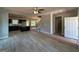 Open layout features new floors, a ceiling fan, fireplace, kitchen, and a staircase at 148 Asa Moseley Rd, Mcdonough, GA 30252