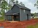 New two-story home featuring a gray exterior with a covered deck perfect for entertaining at 148 Asa Moseley Rd, Mcdonough, GA 30252
