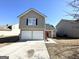 Two-story house with a two-car garage and red door at 270 Marriott Dr, South Fulton, GA 30349