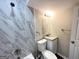 Clean bathroom with marble-look tile and granite vanity at 3961 Cornell Sw Blvd, Atlanta, GA 30331