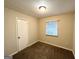 Cozy bedroom with carpet flooring and a window with blinds at 3961 Cornell Sw Blvd, Atlanta, GA 30331
