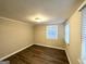 Bright bedroom with wood-look floors and brick accent wall at 3961 Cornell Sw Blvd, Atlanta, GA 30331