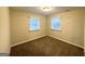 Bright bedroom featuring carpet and two windows with blinds at 3961 Cornell Sw Blvd, Atlanta, GA 30331