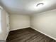 Well-lit bedroom with wood-look floors and brick accent wall at 3961 Cornell Sw Blvd, Atlanta, GA 30331