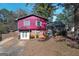 Two-story house with red siding, white door, and a driveway at 4296 Ridgetop Trl, Ellenwood, GA 30294