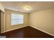 Simple bedroom with dark floors and window blinds at 1134 Wagon Trce, Douglasville, GA 30134