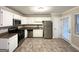 Kitchen with white cabinets, stainless steel appliances, and tile flooring at 1134 Wagon Trce, Douglasville, GA 30134