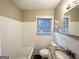 Clean bathroom with tiled walls, bathtub, and granite vanity at 1991 Marvin Sw Ln, Atlanta, GA 30311