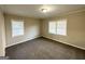 Bright bedroom with neutral walls and carpet, featuring two large windows with blinds at 2540 Cascade Sw Rd, Atlanta, GA 30311