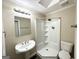 Clean bathroom with pedestal sink, shower, and toilet at 6419 Katherine St, Douglasville, GA 30134