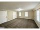 Spacious bedroom with carpet, door, and large windows at 6419 Katherine St, Douglasville, GA 30134