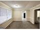 Simple dining room with neutral carpeting and view into kitchen at 6419 Katherine St, Douglasville, GA 30134