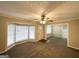 Spacious living room with neutral carpeting, bay window and ceiling fan at 6419 Katherine St, Douglasville, GA 30134