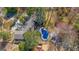 Aerial view of house with in-ground pool and mature trees at 505 River Valley Rd, Sandy Springs, GA 30328