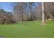 Expansive backyard with lush green grass and mature trees at 505 River Valley Rd, Sandy Springs, GA 30328