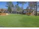 Expansive backyard featuring a lush lawn and a charming wood play set at 505 River Valley Rd, Sandy Springs, GA 30328