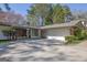 Charming home showcasing an attached two-car garage and well-manicured landscaping at 505 River Valley Rd, Sandy Springs, GA 30328