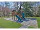 Backyard playground with slide and playhouse offers outdoor fun and entertainment at 505 River Valley Rd, Sandy Springs, GA 30328
