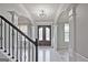 Grand entryway with staircase, high ceilings, and elegant double doors at 315 Lakestone Lndg, Woodstock, GA 30188