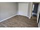 Simple bedroom with wood-look floors and double door closet at 471 Glen Terrace Rd, Auburn, GA 30011