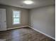 Well-lit bedroom with wood-look floors and ample closet space at 471 Glen Terrace Rd, Auburn, GA 30011