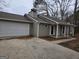 Tan house exterior with attached garage and porch at 471 Glen Terrace Rd, Auburn, GA 30011
