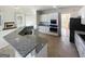 Open concept kitchen features modern appliances, granite countertops, and a seamless flow into the living area at 3905 Colonial Sw Trl, Lilburn, GA 30047