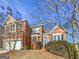 Traditional two-story brick home with a well-manicured front yard and attached two-car garage at 3905 Colonial Sw Trl, Lilburn, GA 30047