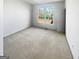 Carpeted bedroom with a large window letting in natural light at 3905 Colonial Sw Trl, Lilburn, GA 30047