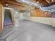 Unfinished basement with exposed ceiling and concrete flooring at 3905 Colonial Sw Trl, Lilburn, GA 30047