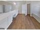 Large bathroom features wood floors, soaking tub, double sinks and plenty of storage space in white cabinets at 3905 Colonial Sw Trl, Lilburn, GA 30047