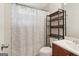 Functional bathroom featuring a toilet, a vanity with sink, and a shower-tub combo with a decorative curtain at 1144 Kipling Se St, Atlanta, GA 30315