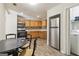 Efficient kitchen with stainless steel appliances, warm wood cabinets, and adjacent dining area at 1144 Kipling Se St, Atlanta, GA 30315