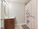 Simple bathroom featuring a vanity with sink and a shower-tub combo with a decorative curtain at 1144 Kipling Se St, Atlanta, GA 30315