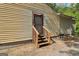 Back door with wooden stairs, offering direct access to a wooden grill in the backyard at 1144 Kipling Se St, Atlanta, GA 30315