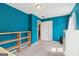 Cozy bedroom featuring teal walls, neutral carpet, and a functional built-in bookshelf, providing ample storage at 1144 Kipling Se St, Atlanta, GA 30315