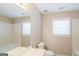 Bathroom with a single vanity, bathtub, and window at 380 River Point Dr, Mcdonough, GA 30252