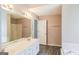 Double vanity bathroom with white cabinets and a separate tub and shower at 380 River Point Dr, Mcdonough, GA 30252
