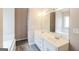 Double vanity bathroom with white cabinets and a bathtub at 380 River Point Dr, Mcdonough, GA 30252