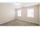 Well-lit bedroom featuring neutral walls and carpet at 380 River Point Dr, Mcdonough, GA 30252